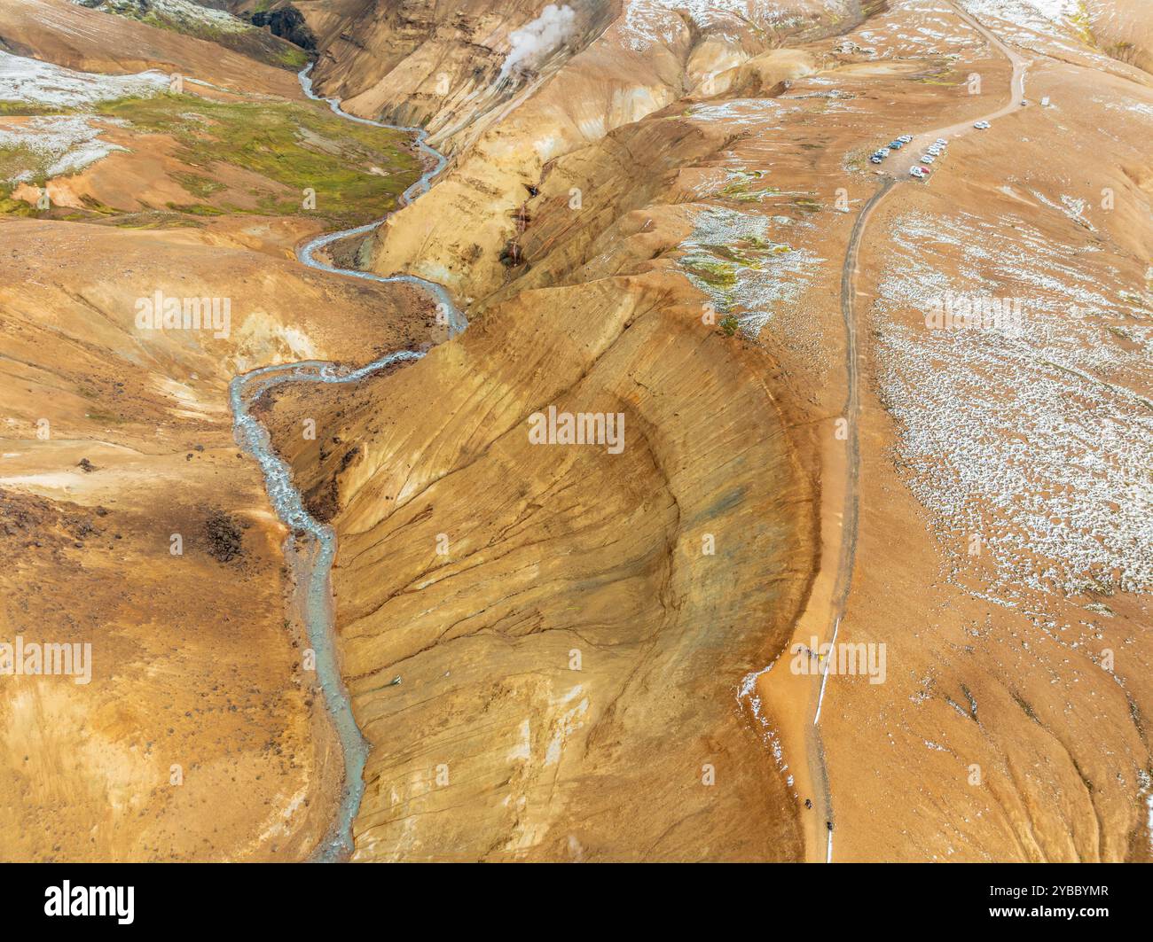Steaming hot springs and colourful rhyolite mountains, parking lot,  aerial view, Hveradalir geothermal area, Kerlingarfjöll, Icelandic highlands, Ice Stock Photo