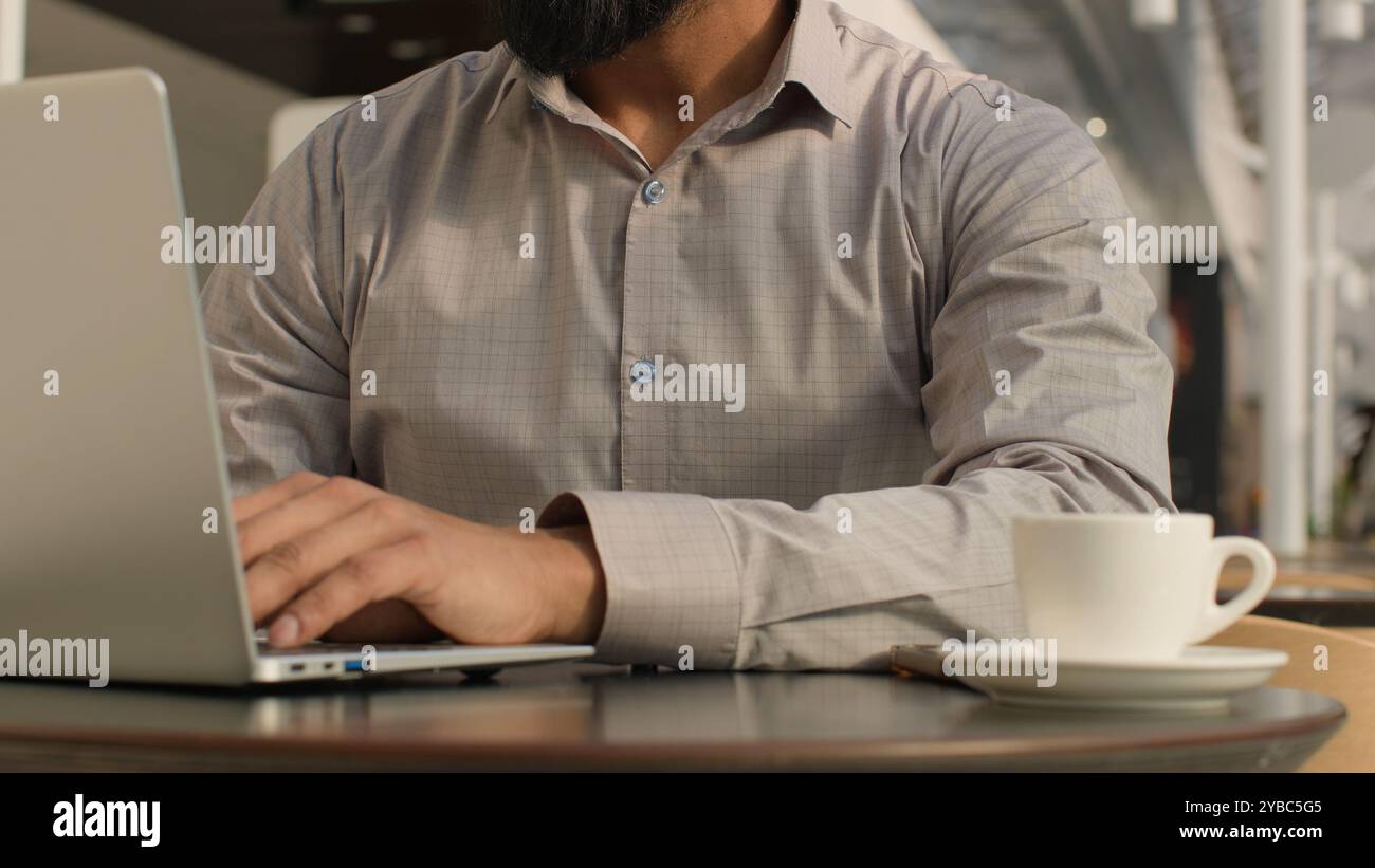 Close-up unrecognizable man guy typing on laptop businessman freelancer programmer working remote on internet using computer application in cafe make Stock Photo