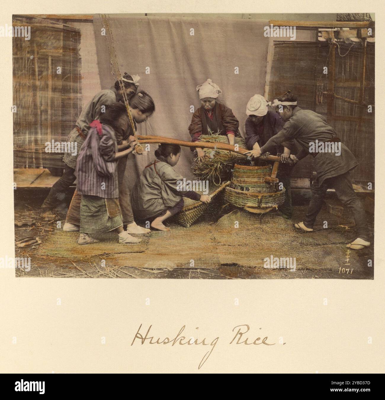 Traditional process of husking rice hi-res stock photography and images ...