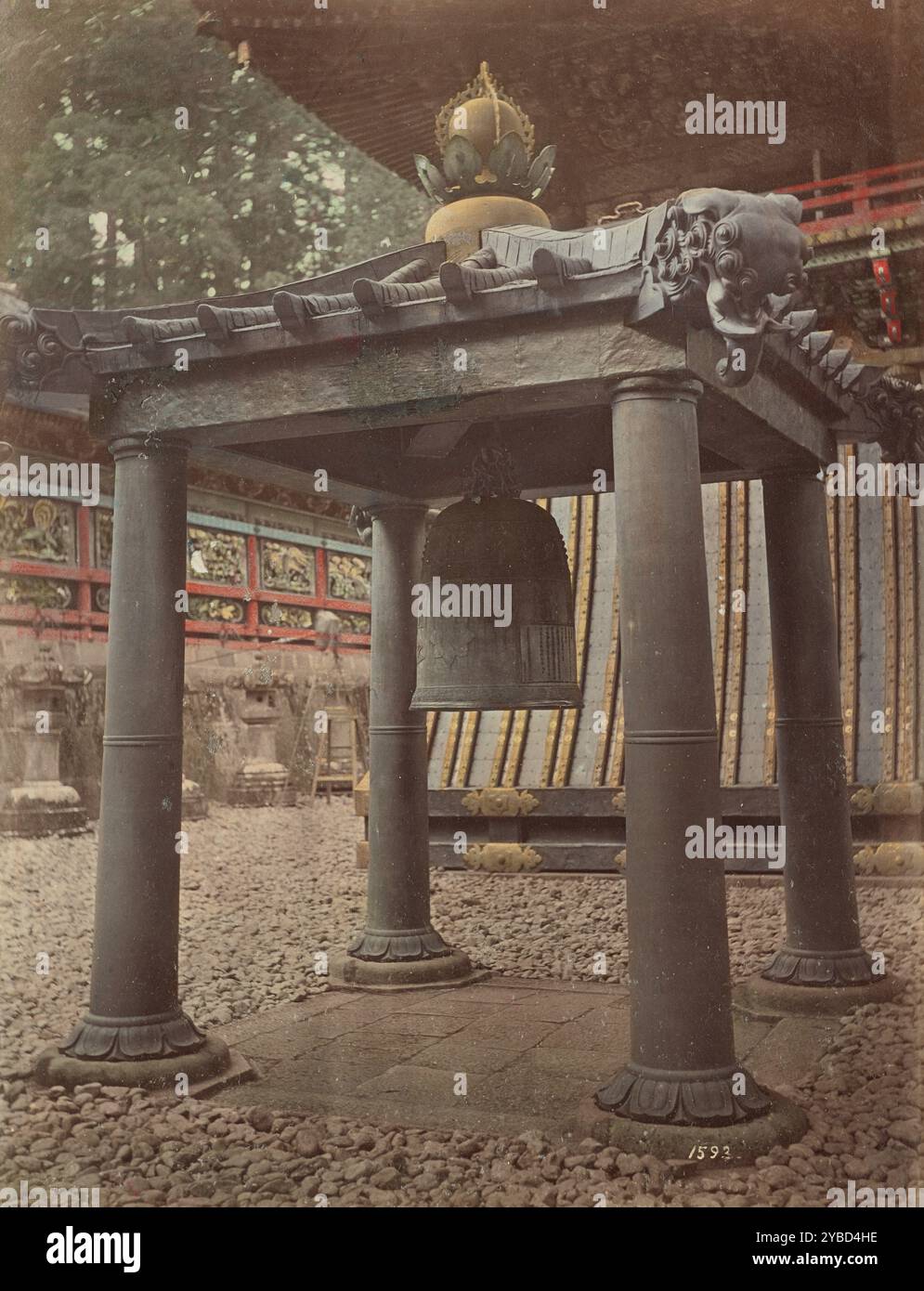 Korean Bell at Nikko, 1870s-1890s. Large bronze bell suspended from a roof supported by four columns. Stock Photo