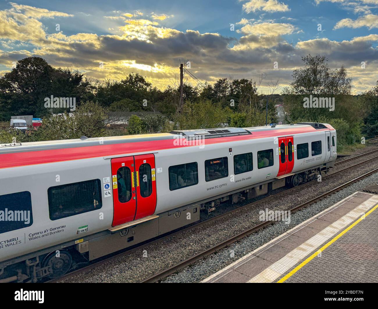 Pontyclun, Wales - 1 October 2024: Transport for Wales Class 197 diesel commuter train stopped at the village station of Pontyclun - Smartphone Captured Stock Image