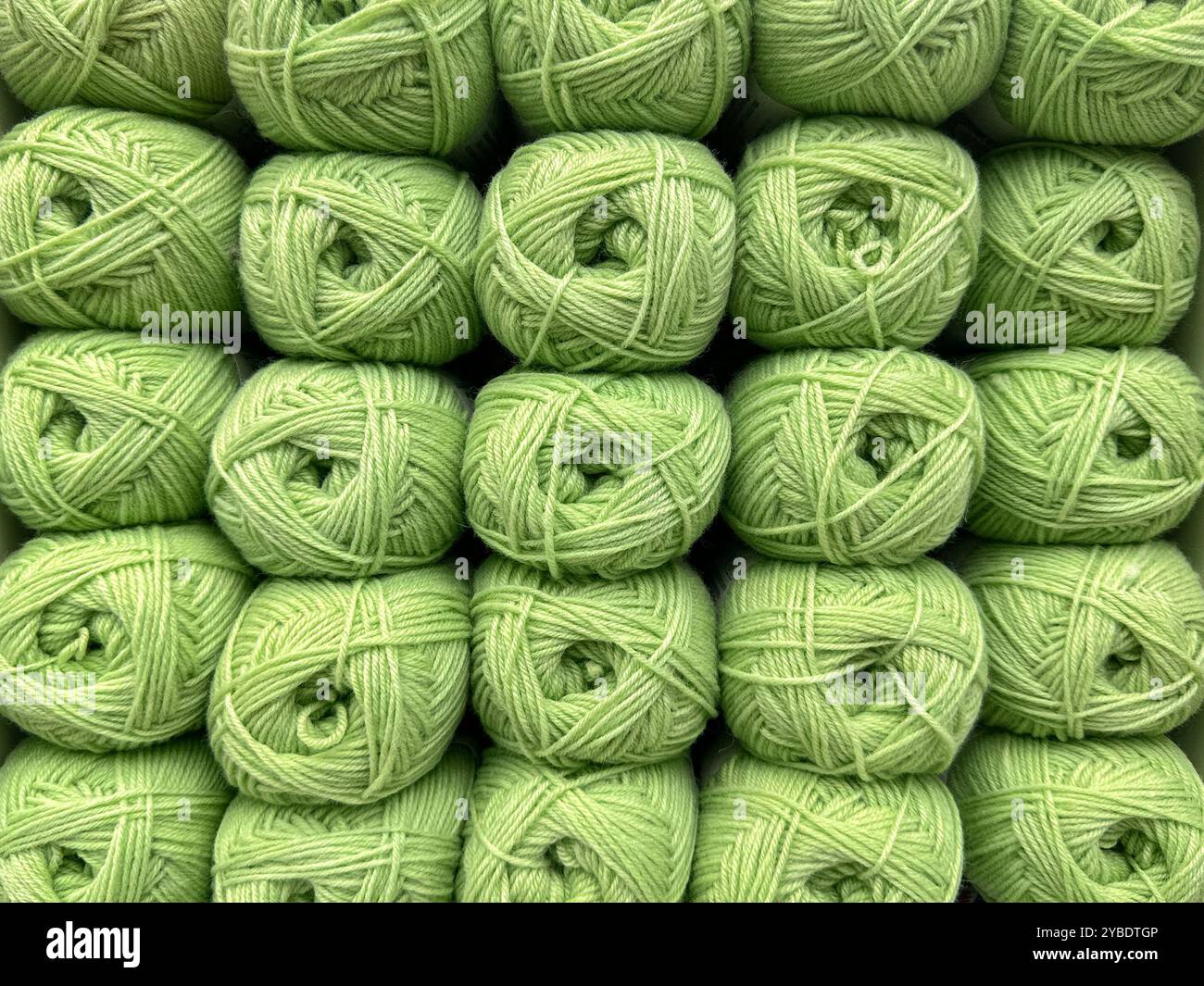 Close up view of balls of green wool. - Smartphone Captured Stock Image