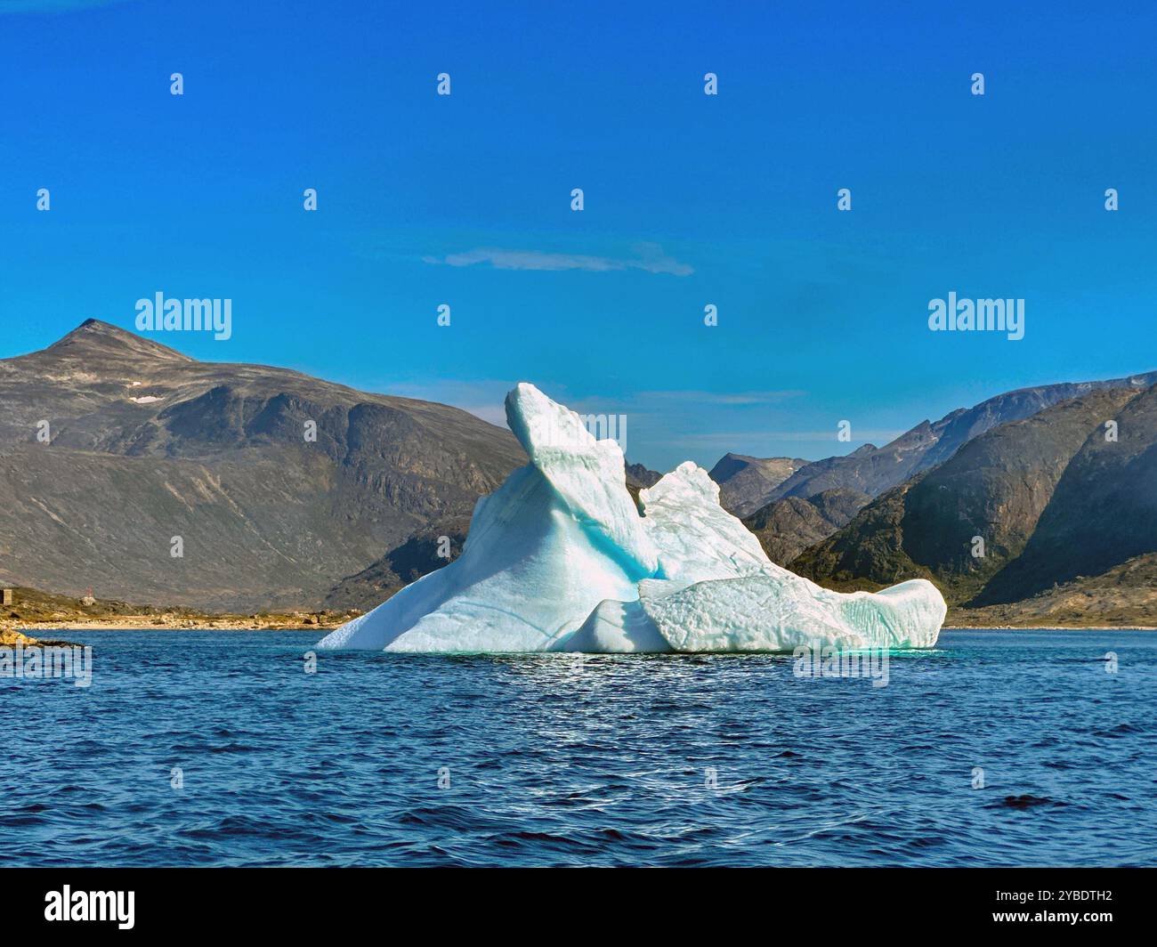 Scenic view of a large iceberg on a blue sea in a fjord in Greenland - Smartphone Captured Stock Image