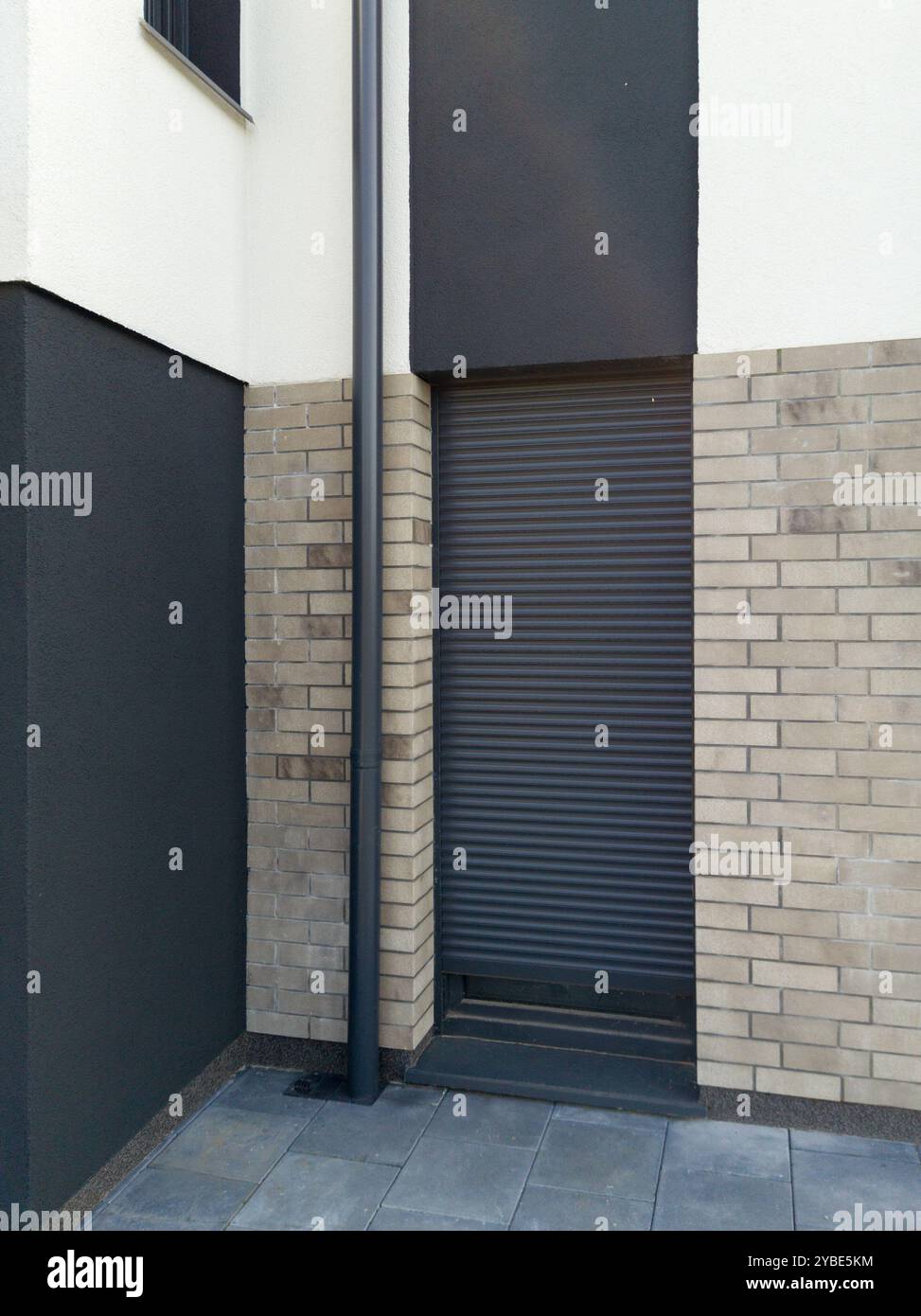 Curated visual reference: Fresh Look at Modern Gray Brick House With Closed Roller Shutter Stock Photo
