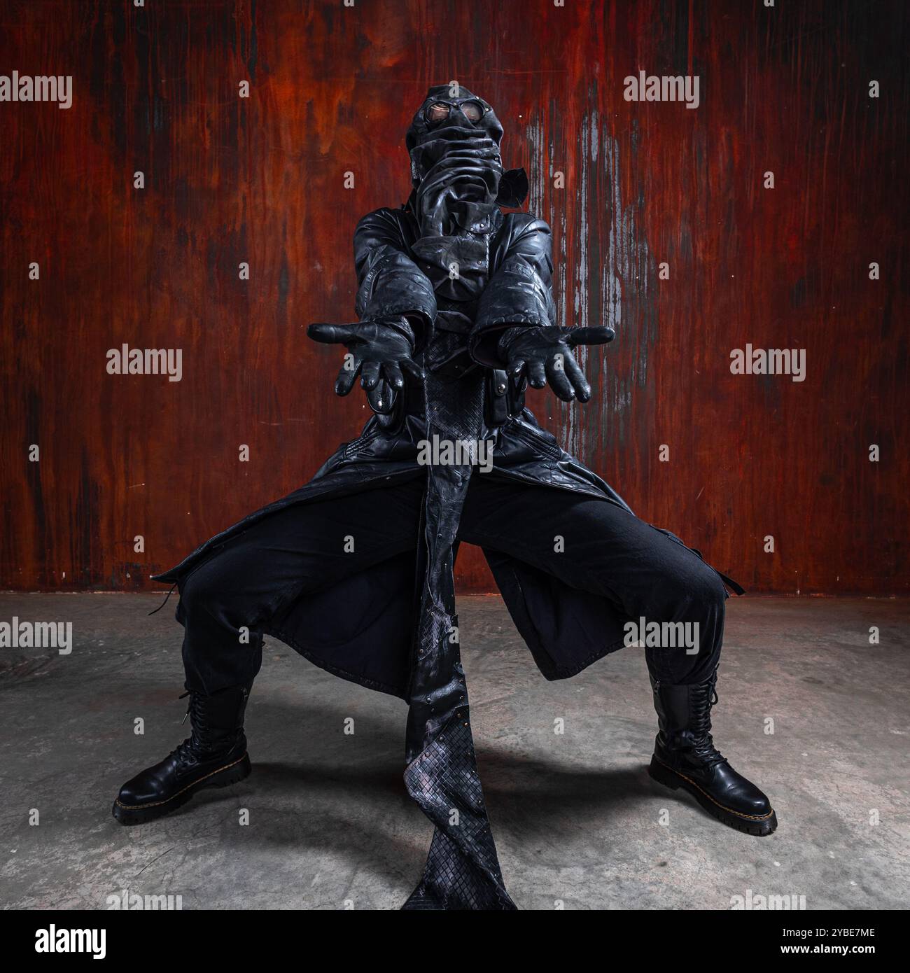 A strange post apocalyptic freak in a leather suit wearing a mask with ...