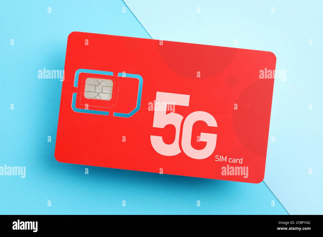 Red 5G SIM card on light blue background, top view Stock Photo