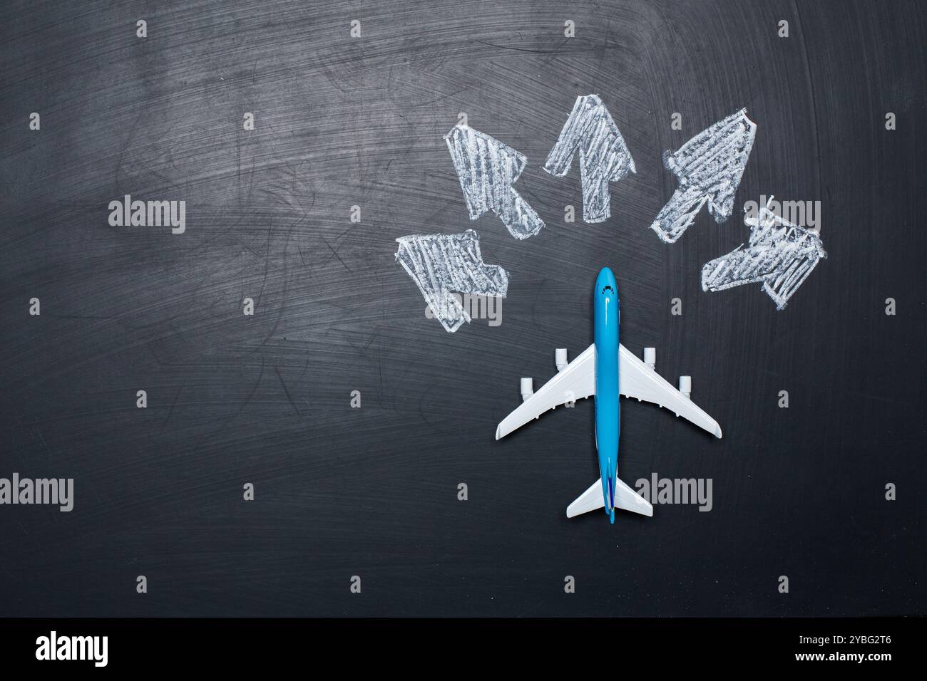 toy airplane over chalkboard background and arrows drawings Stock Photo ...