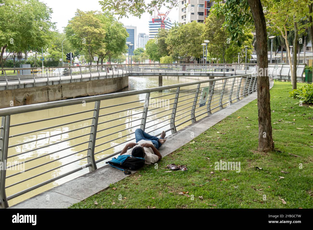 A man sleeping near Rochor Channel on the ground Singapore Stock Photo