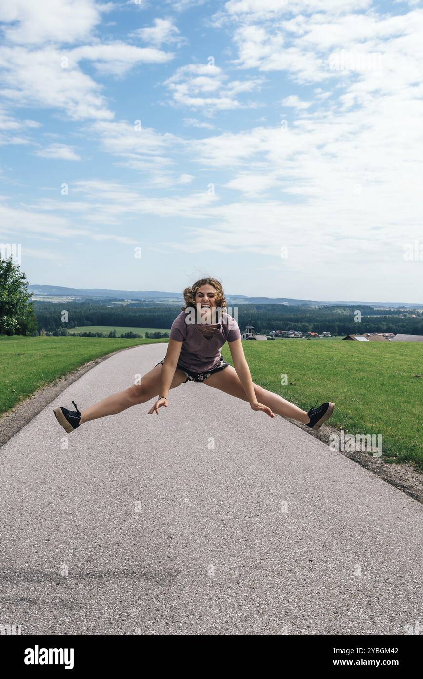 Young woman jumps joyfully on hi-res stock photography and images - Alamy