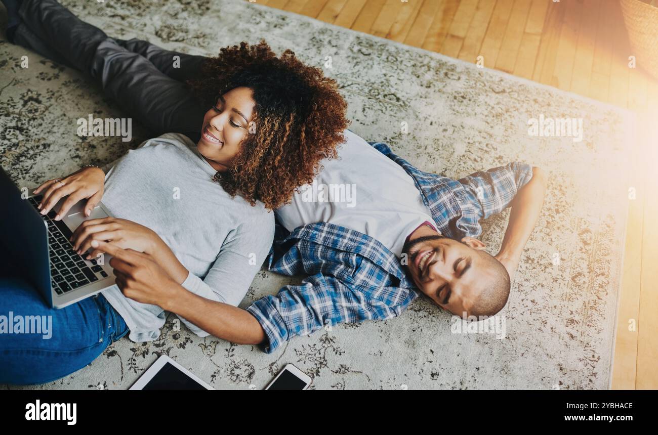Happy, relaxed and carefree couple bonding together on the living room floor at home. Loving, affectionate and smiling boyfriend and girlfriend Stock Photo