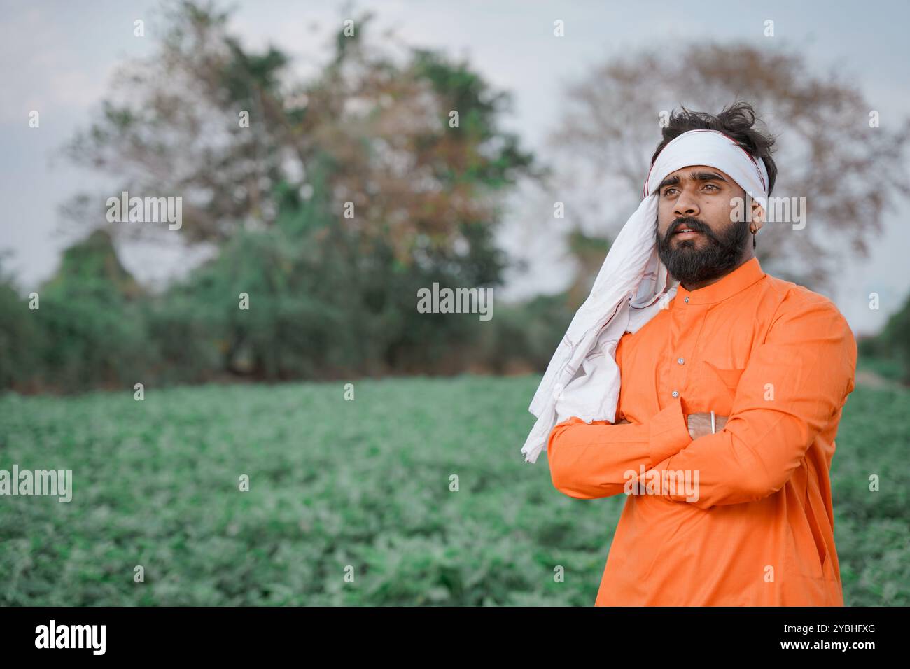 Indian farmer, young, standing on an agricultural field Stock Photo - Alamy