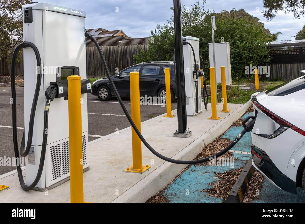 EV car plugged in with fast charger at charging station Stock Photo - Alamy
