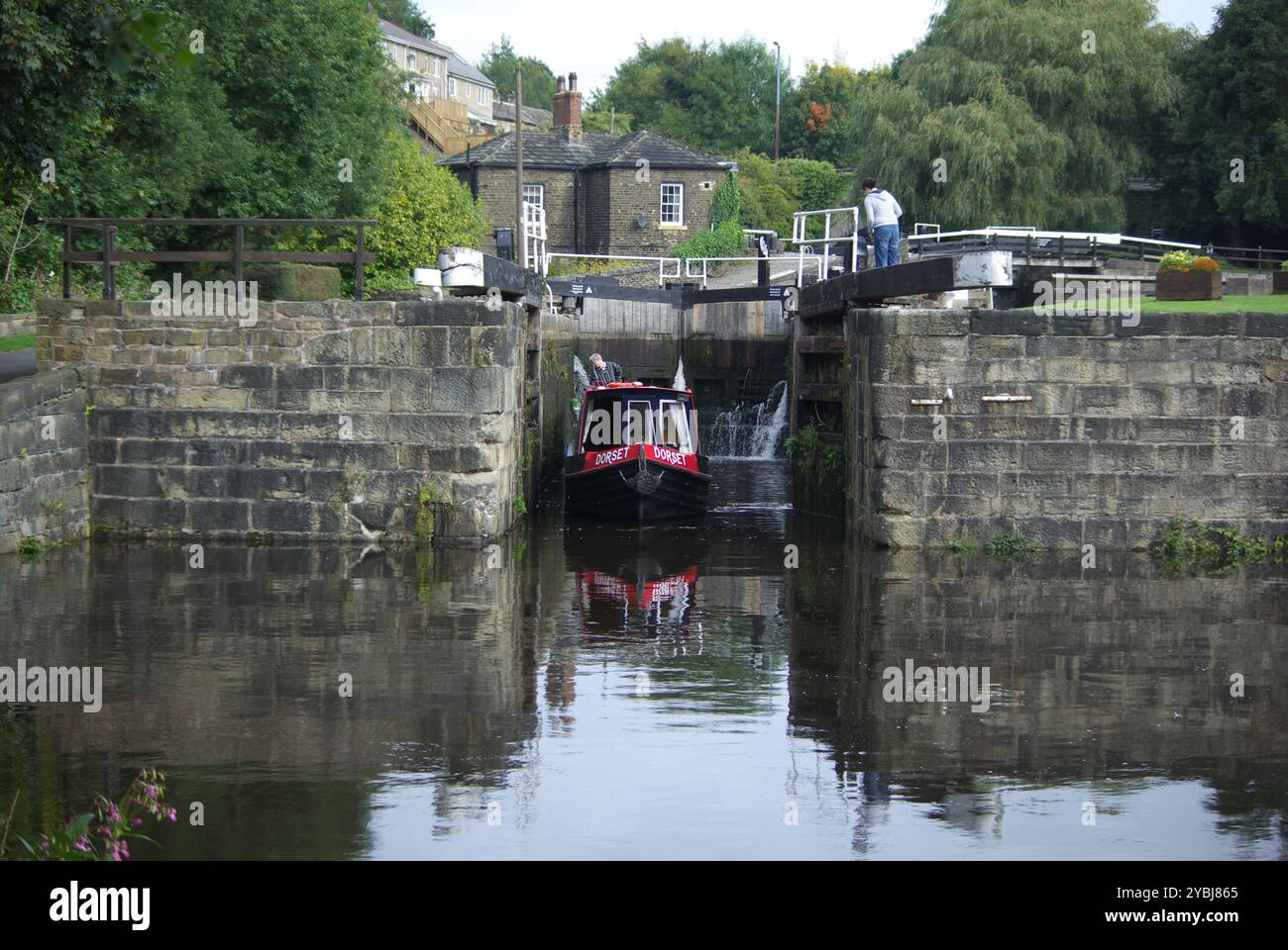 Narrowboat leaving a lock on the Calder and Hebble Navigation. Stock Photo