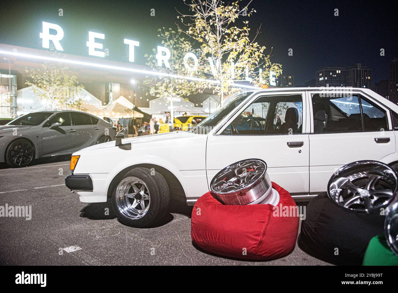 Classic whiteToyota Corolla from 1980s with fashionable rims at Kyiv Car Fest October 2024 helping to grow rims retail and repair business in Ukraine. Stock Photo
