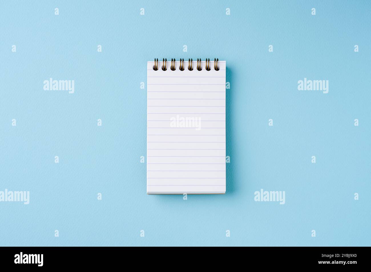Top view of lined notebook on blue background Stock Photo