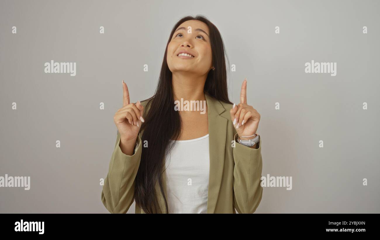 Asian woman pointing upwards hi-res stock photography and images - Alamy