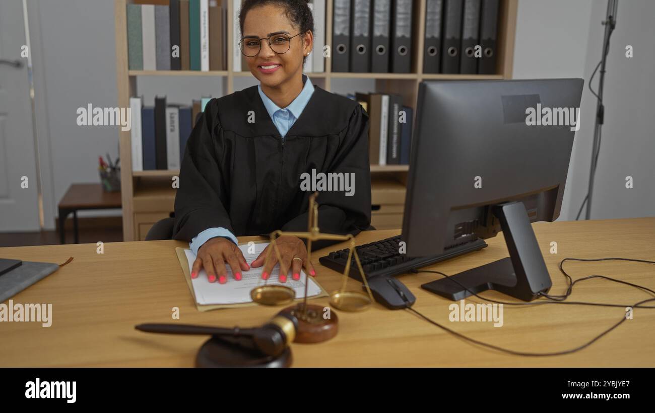Female judge working at her office desk, smiling and wearing glasses in ...