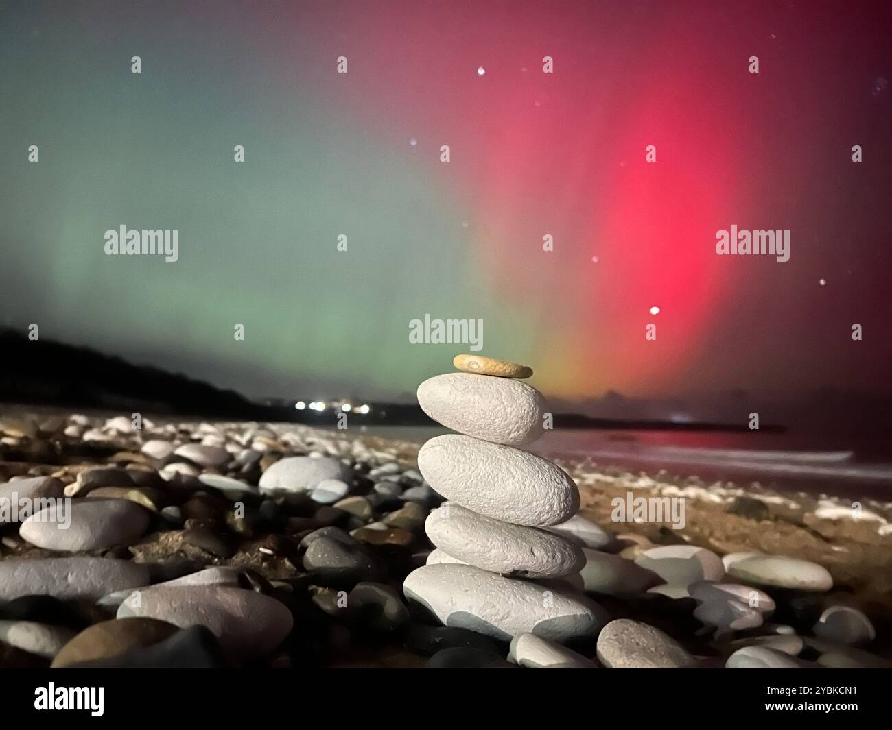 Mesmerizing Northern Lights dance over Bridlington Beach, casting a magical glow on the serene coastline. - Smartphone Captured Stock Image