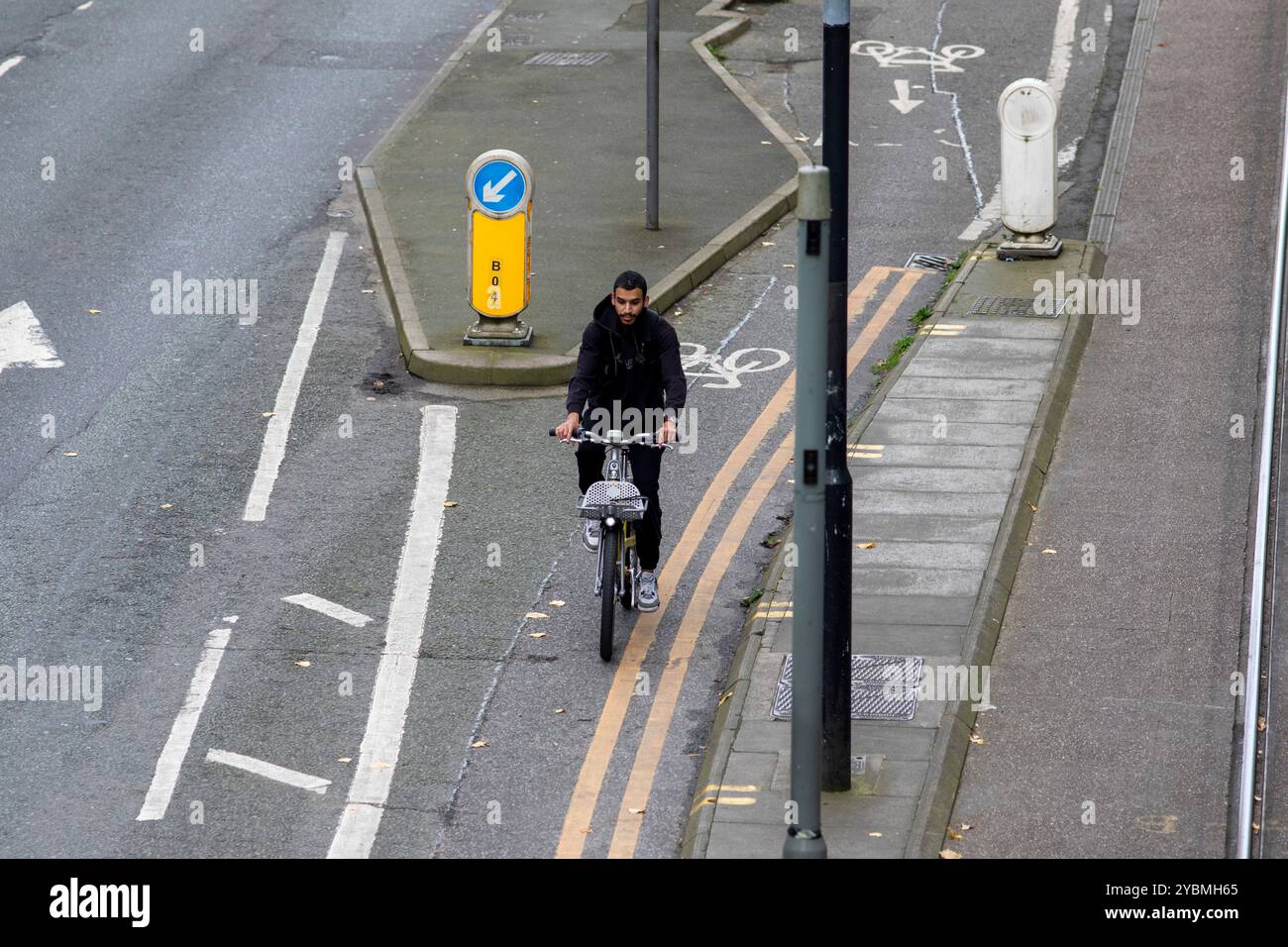 a-cyclist-on-a-rental-bike-on-a-cycle-lane-next-to-manchester-metrolink