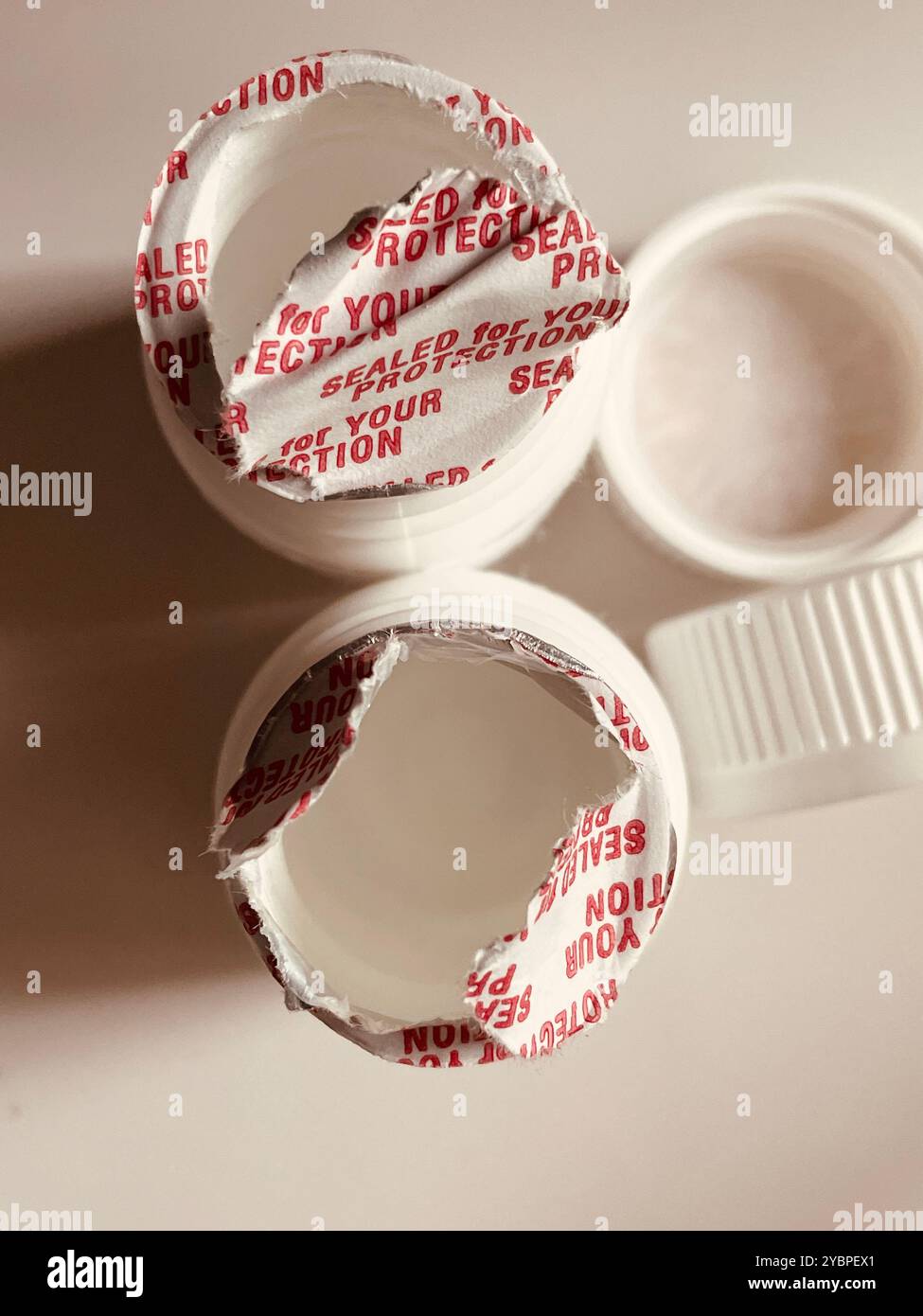 Prescription Pill Bottles with protective seals Torn Open, 2024, USA - Smartphone Captured Stock Image