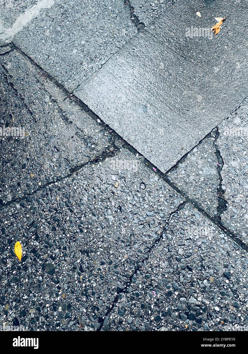 Close-up of a cracked and weathered portion of a concrete sidewalk, 2024, New York City, United States - Smartphone Captured Stock Image