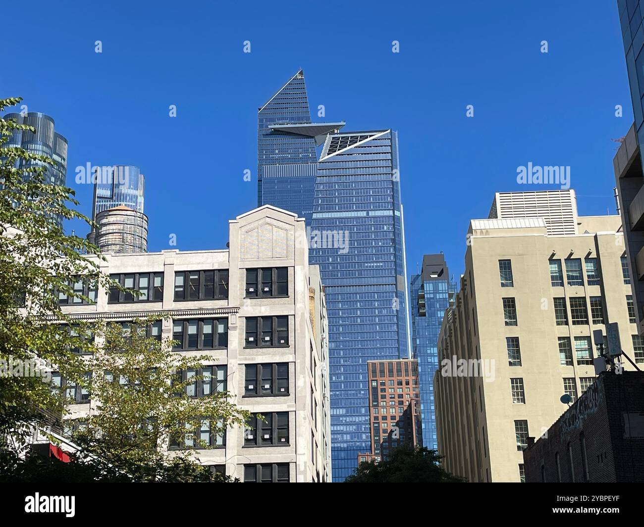 The skyscrapers of Hudson Yards as seen from the High Line, an elevated freight rail line now public park, 2024, New York City, USA - Smartphone Captured Stock Image