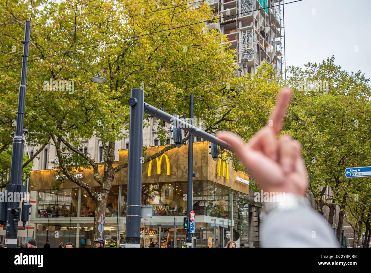 Rotterdam, South Holland, Netherlands. 19th Oct, 2024. A pro-Palestine demonstrator gives a McDonalds restaurant the middle finger after it has been reported that McDonalds has provided food to Israeli soldiers in Gaza. After more than a year of fighting and genocide in Gaza, pro-Palestinian demonstrators again marched through Rotterdam, the Netherlands, calling for an end to the violence. (Credit Image: © James Petermeier/ZUMA Press Wire) EDITORIAL USAGE ONLY! Not for Commercial USAGE! Stock Photo