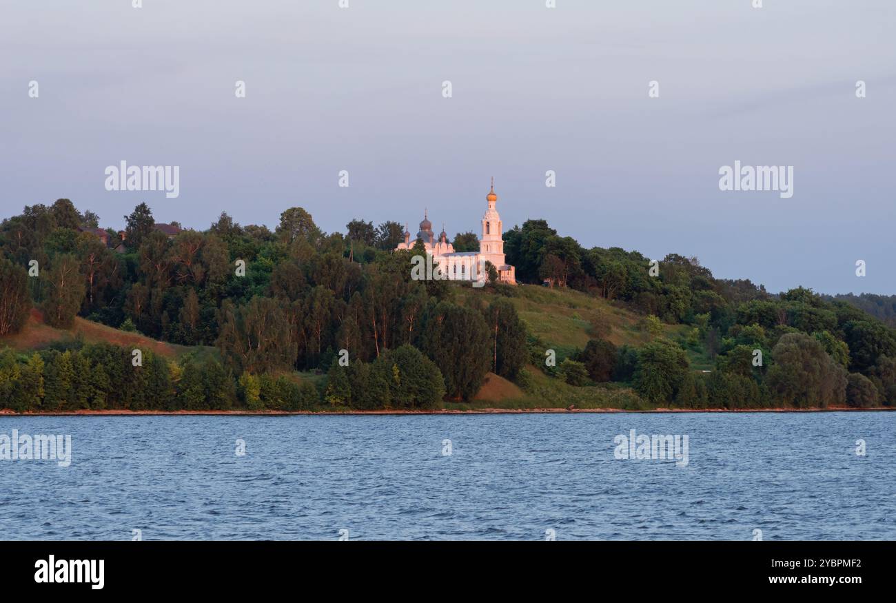 The church illuminated by the setting sun on the banks of the Volga River Stock Photo