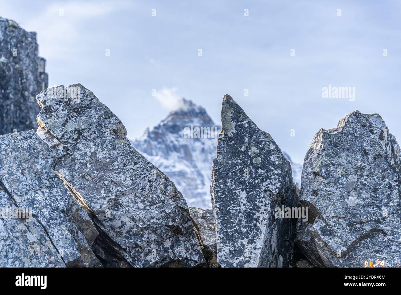 Rocks on mountain Trail with mountains in the background Stock Photo