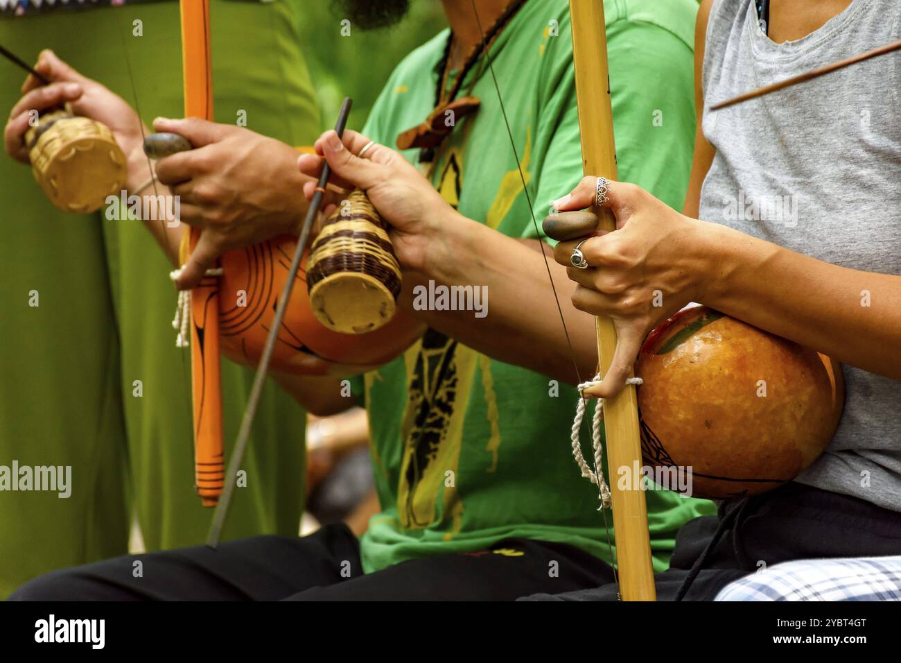 Musicians playing an Afro Brazilian percussion musical instrument ...