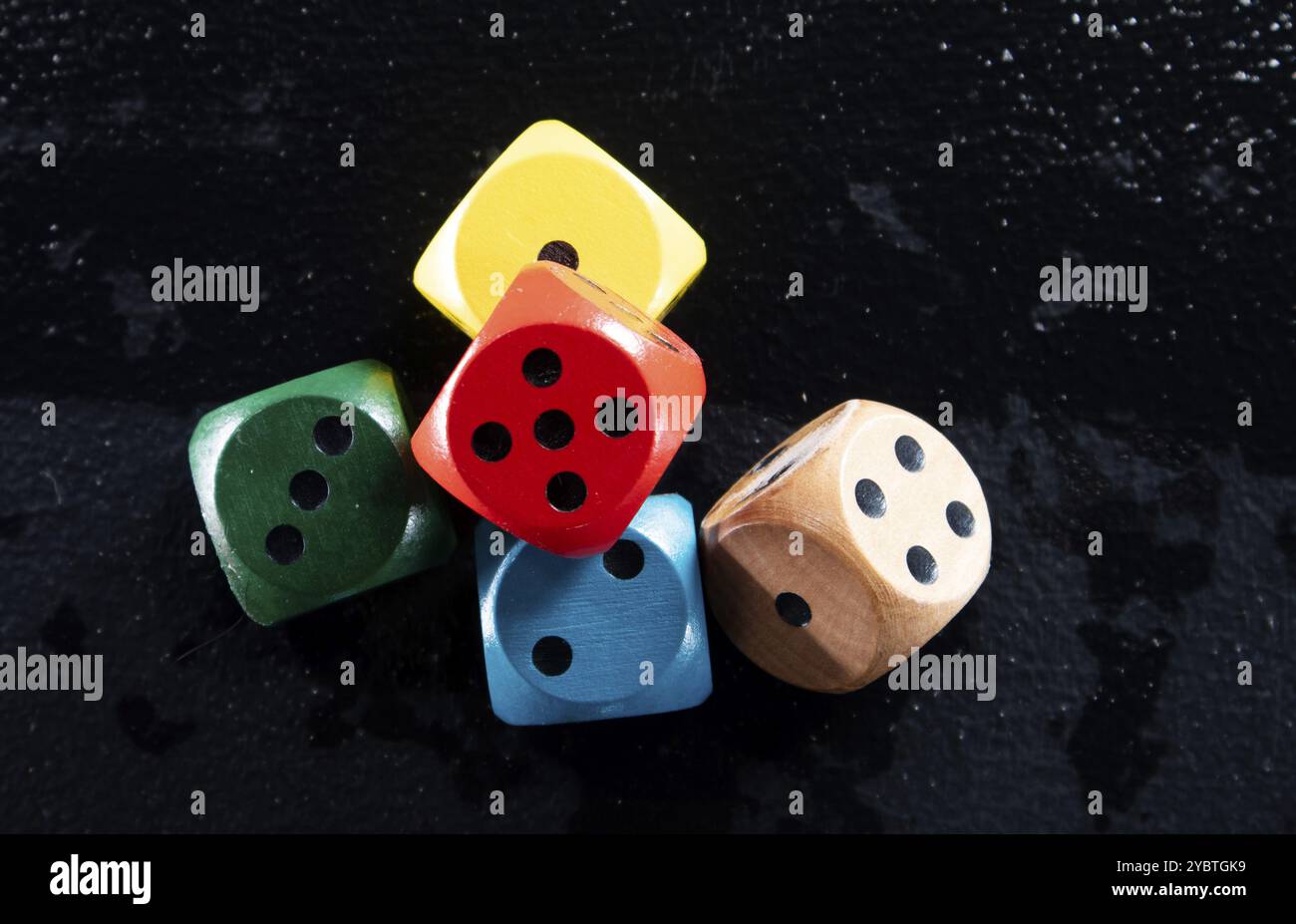 Representation of a set of colored game dice on a black background Stock Photo