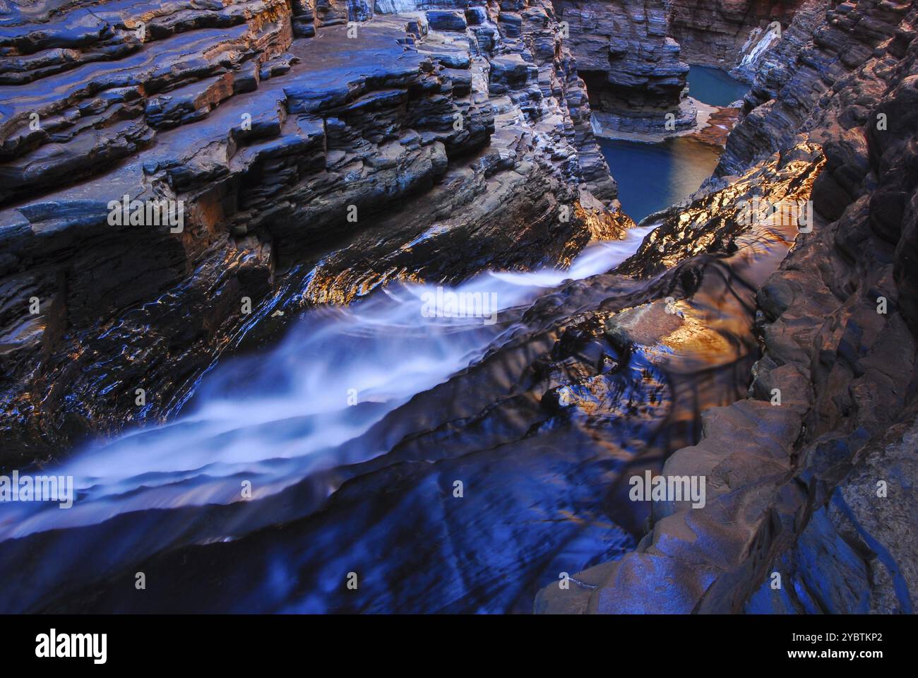 Gorge with rocks and flowing blue water blending into the landscape in ...