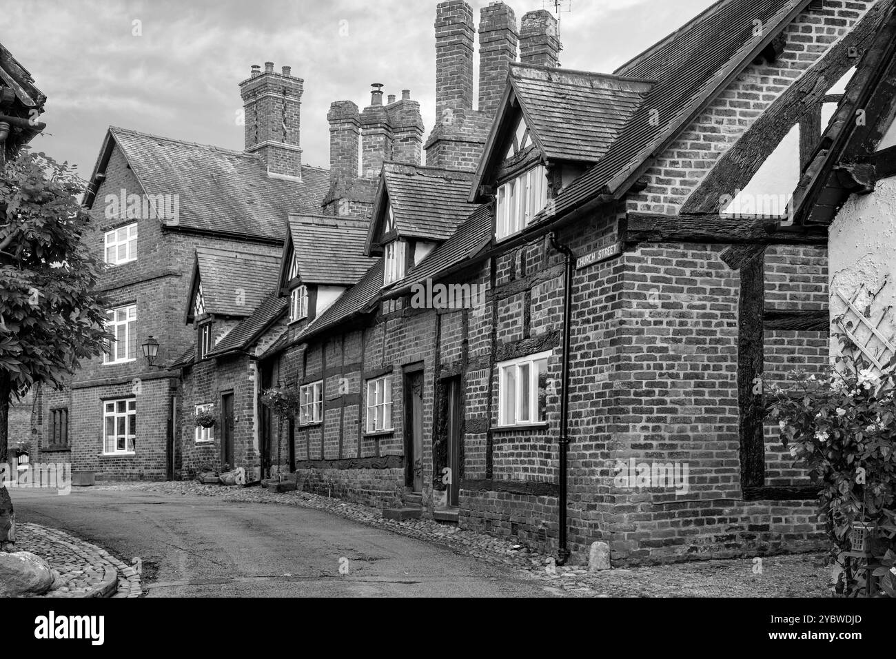 Black and white image of Half timbered black and white country cottages in then picturesque  idyllic Cheshire village of Great Budworth Stock Photo