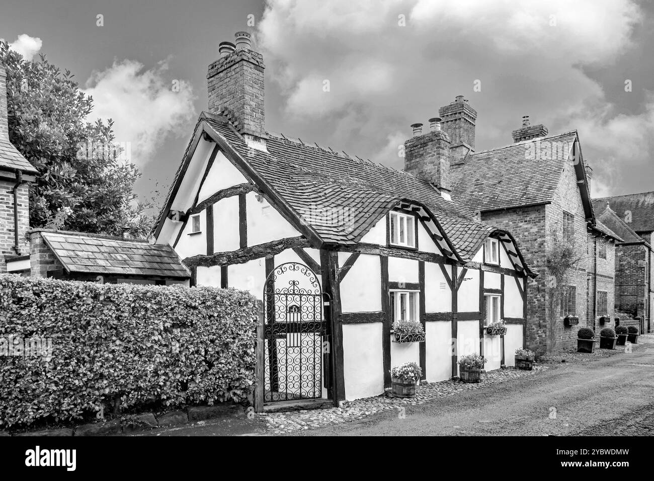 Black and white image of Half timbered black and white country cottage in Church Street in the picturesque  idyllic Cheshire village of Great Budworth Stock Photo