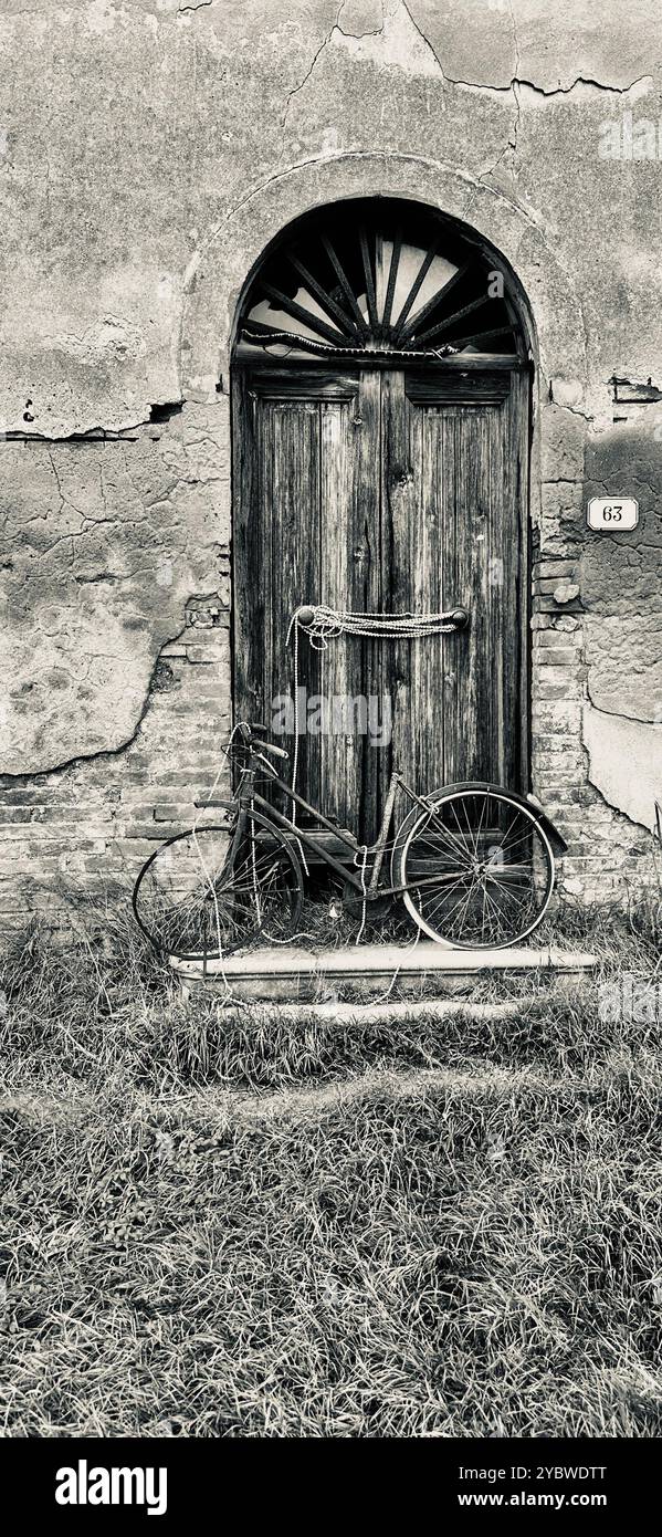 old bicycle next to an old gate , Italy , Tuscany - Smartphone Captured Stock Image