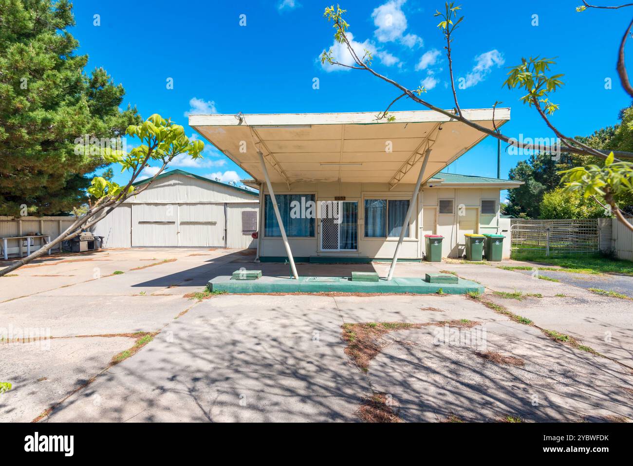 A former petrol or service station with its trademark large awning, now used as a family home in central western New South Wales, Australia Stock Photo