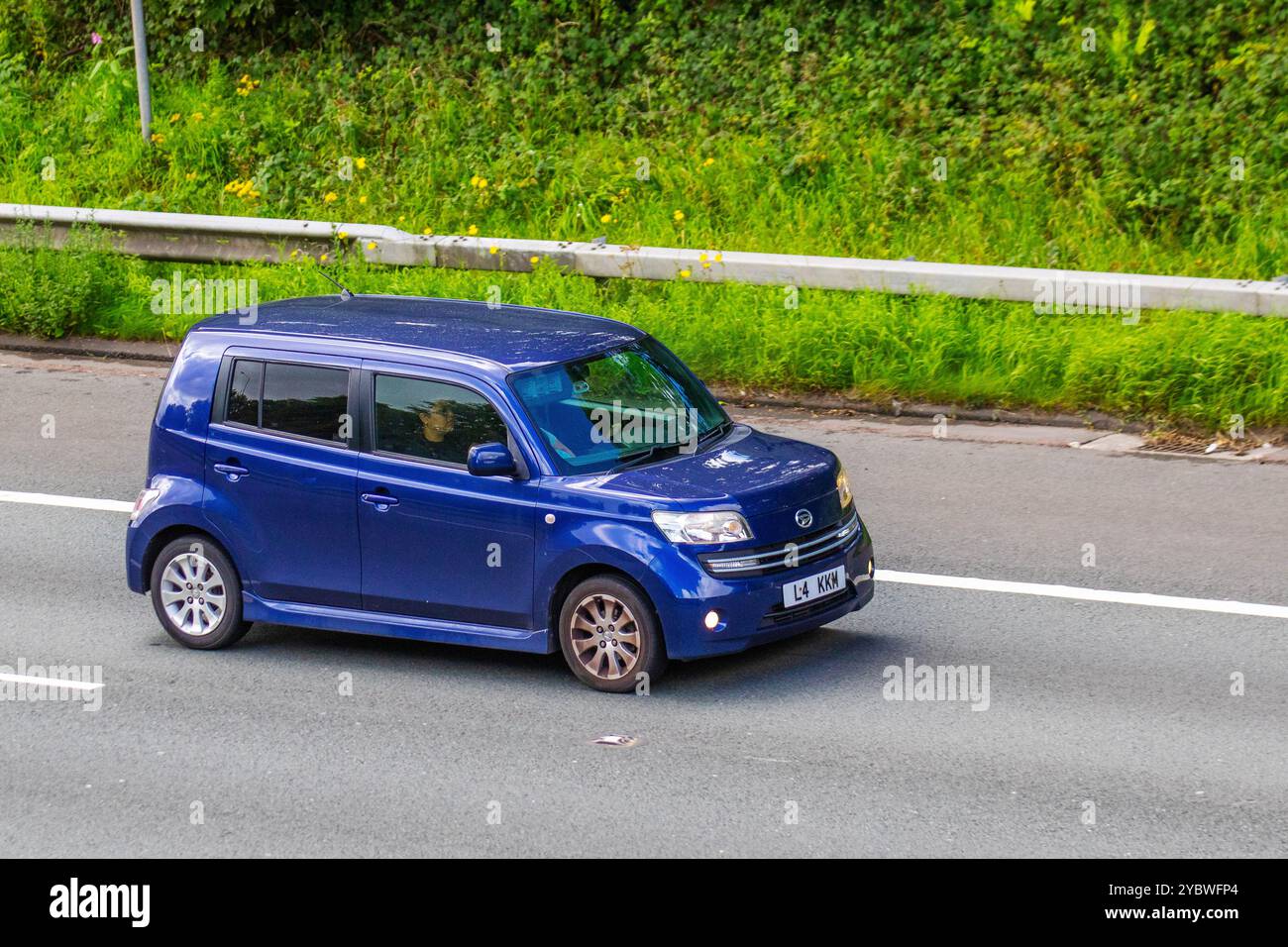 2008 Blue Daihatsu Materia DVVT Car Hatchback Petrol 1495 cc, travelling on the M6 motorway, UK Stock Photo