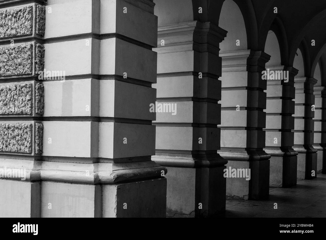 Layered Light to Dark: Stone Wall , Pillars and Arch Frames of City Hall in Novi Sad, Serbia. 2024 Black and White Stock Photo
