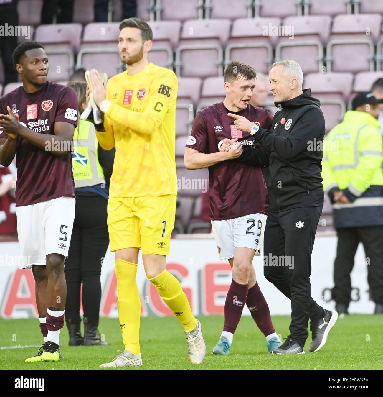 Oriam Sports Centre Edinburgh.Scotland.UK 19 Oct, 2024.  Hearts Aidan Denholm Press conference for Cinch Premiership Match vs St Mirren. Hearts players applaud the fans at full time, L/r Daniel Oyegoke, goalkeeper Craig Gordon, James Penrice & head Coach Neil Critchley . Credit: eric mccowat/Alamy Live News Stock Photo