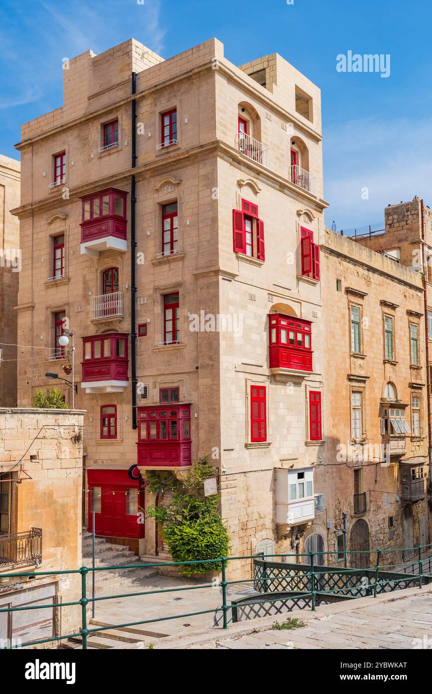 Traditional Maltese buildings with colourful balconies in historic old town of Valletta, Malta Stock Photo