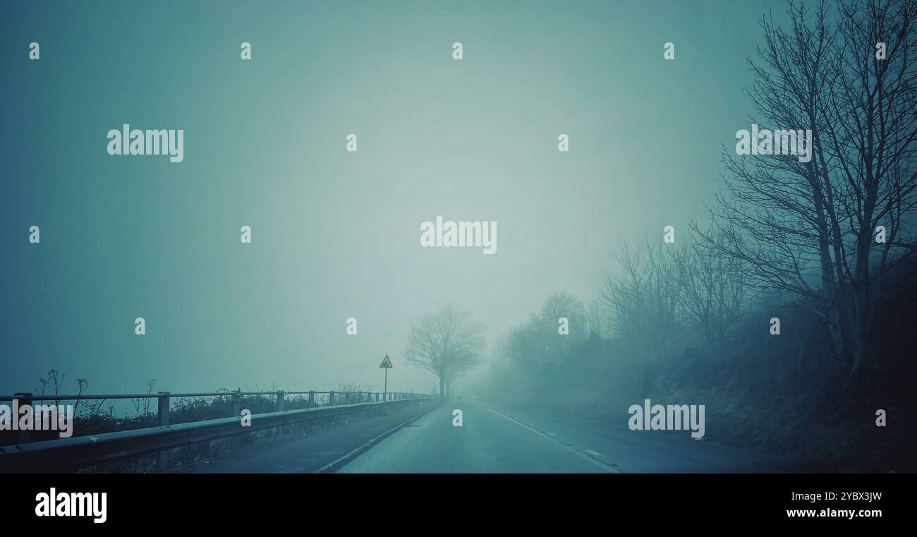 A photograph of a misty mountain road, rural landscape scene with copy space - Smartphone Captured Stock Image