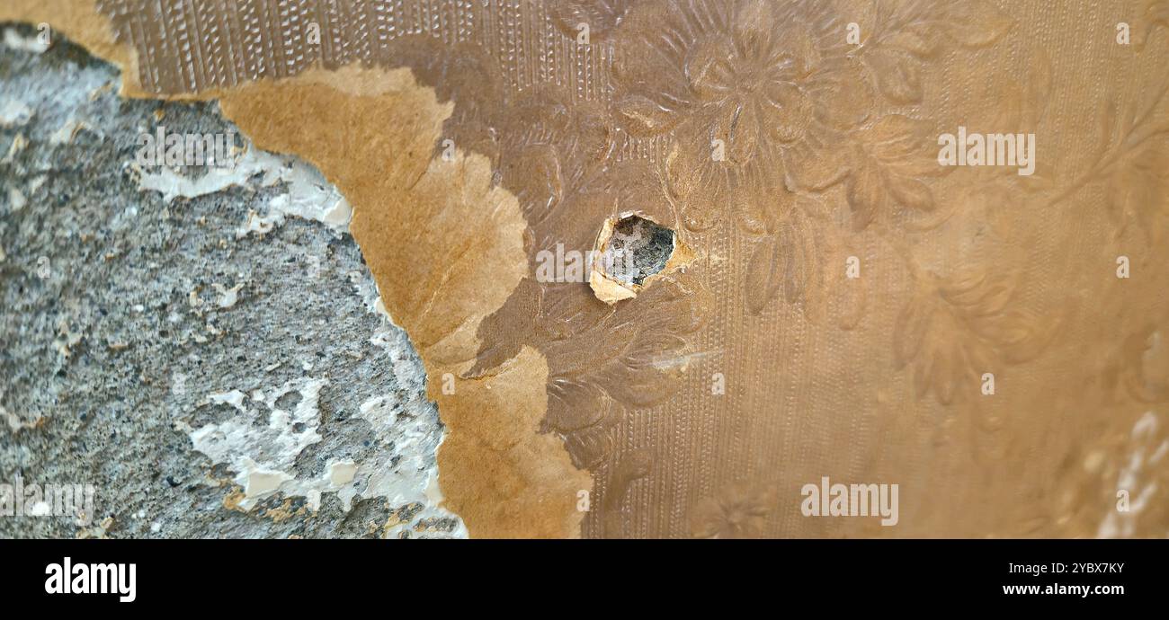 Peeling wallpaper revealing damaged textured wall - Smartphone Captured Stock Image