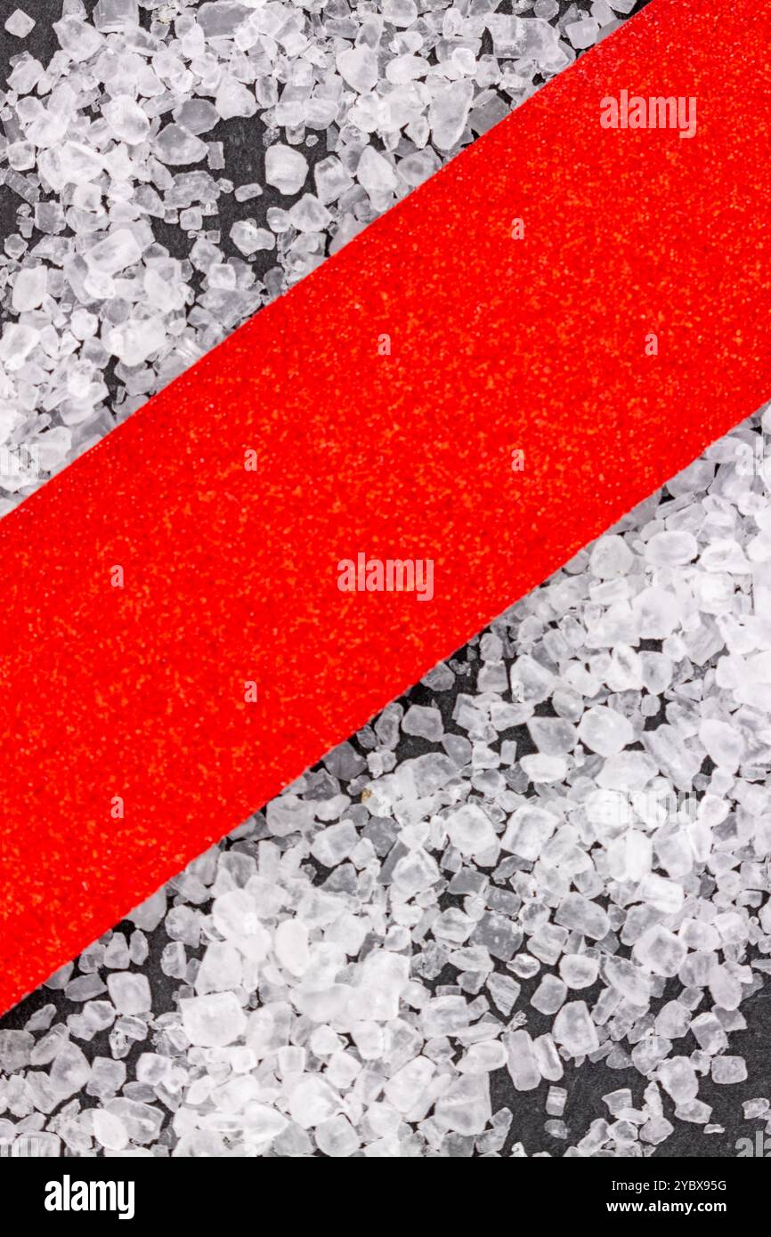 This image features a close-up view of a textured surface with a diagonal red strip running through it. Stock Photo