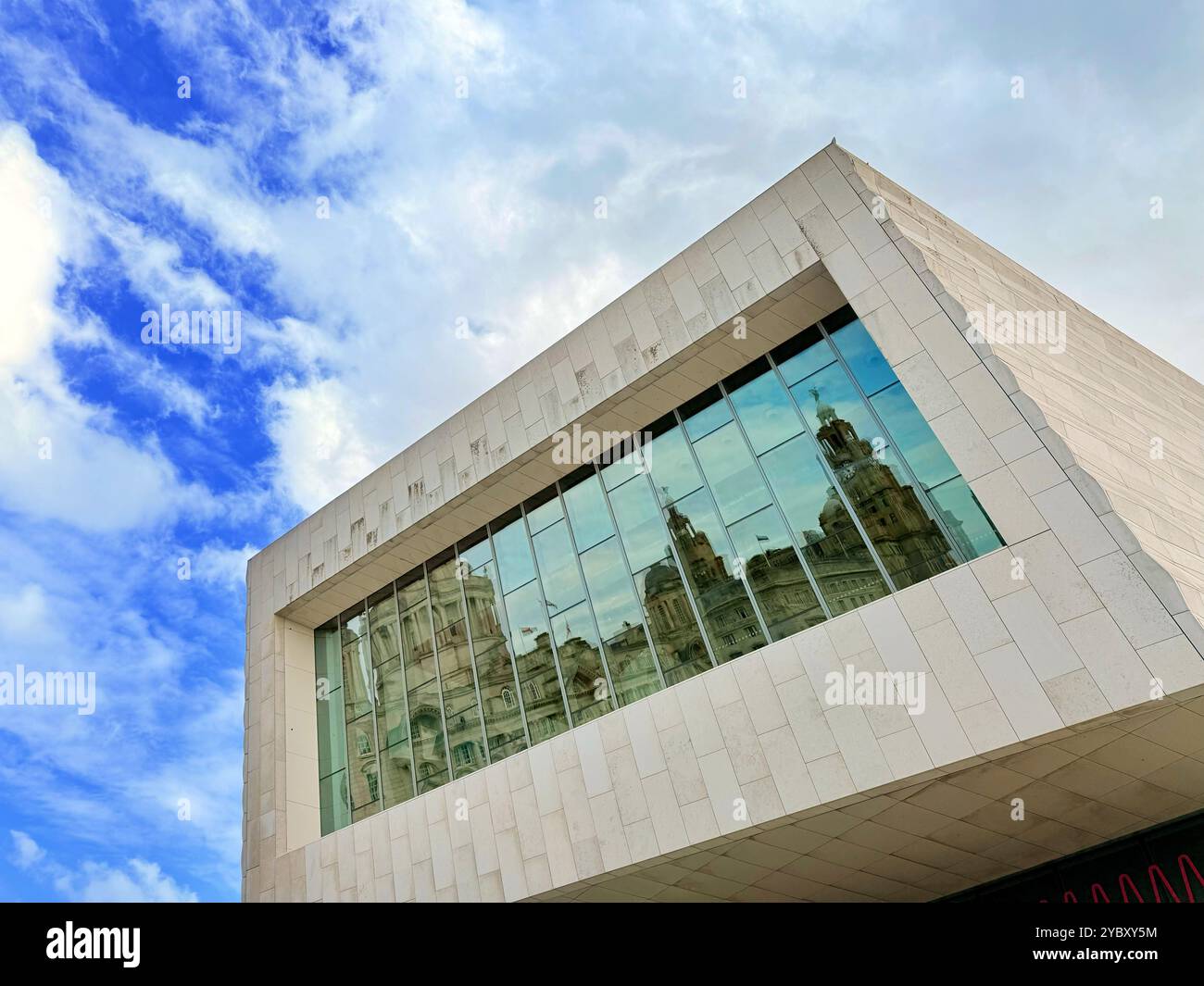 The three Graces on Liverpool water front reflected in the windows of the Museum of Liverpool, UK - Smartphone Captured Stock Image