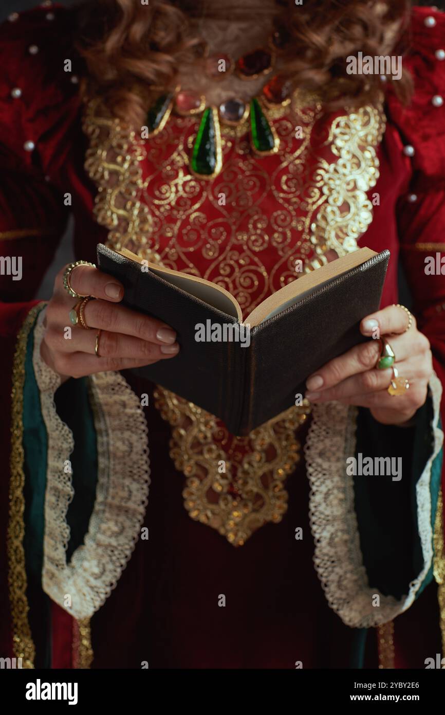 Closeup on medieval queen in red dress with book Stock Photo - Alamy