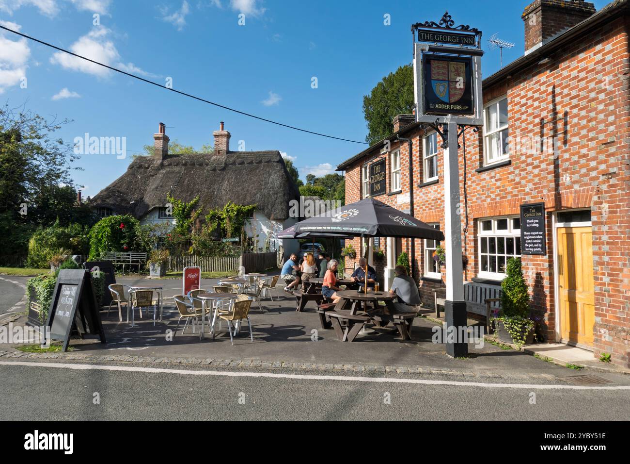 Thatched cottage and The George Inn along the Bourne Valley, St Mary Bourne, near Andover, Hampshire, England, United Kingdom, Europe Stock Photo