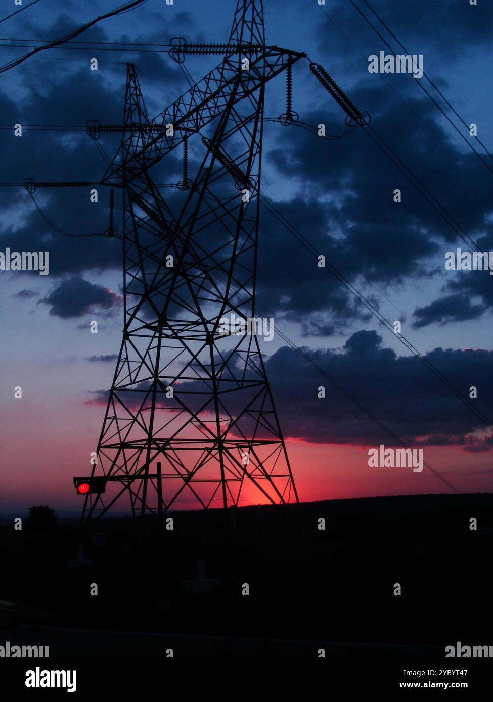 A colourful red, orange, and blue sunset with dark clouds in the ...
