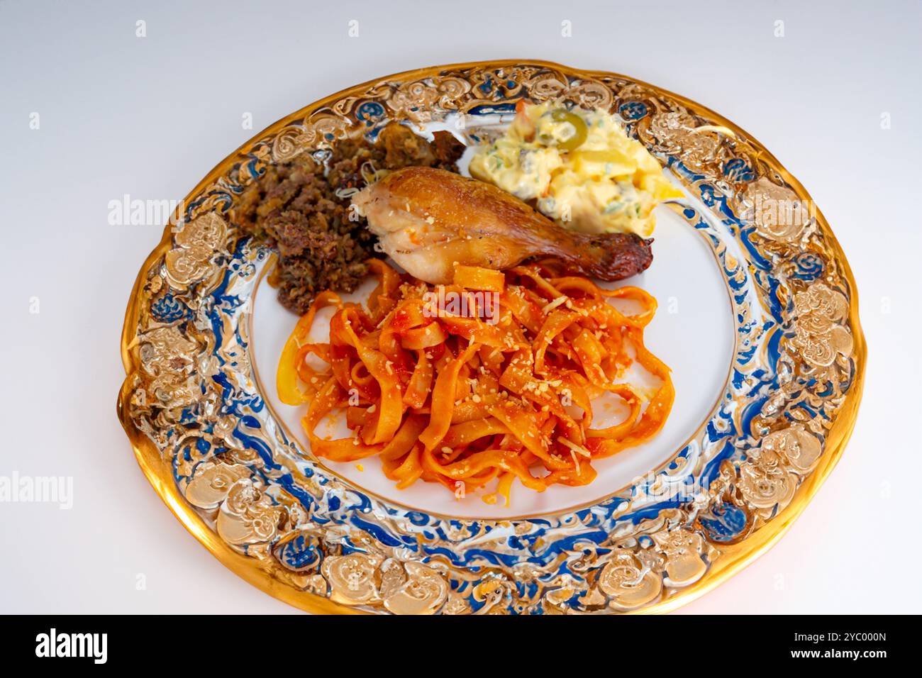 Traditional Brazilian Sunday lunch, pasta, roast chicken and mayonnaise salad with potatoes Stock Photo