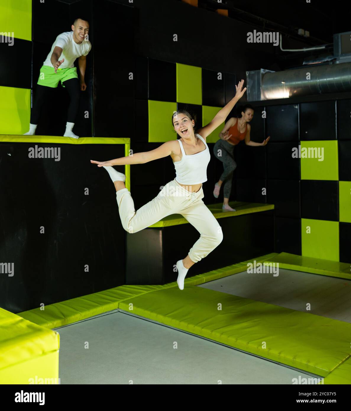 Excited young girl jumping at indoor trampoline center Stock Photo - Alamy