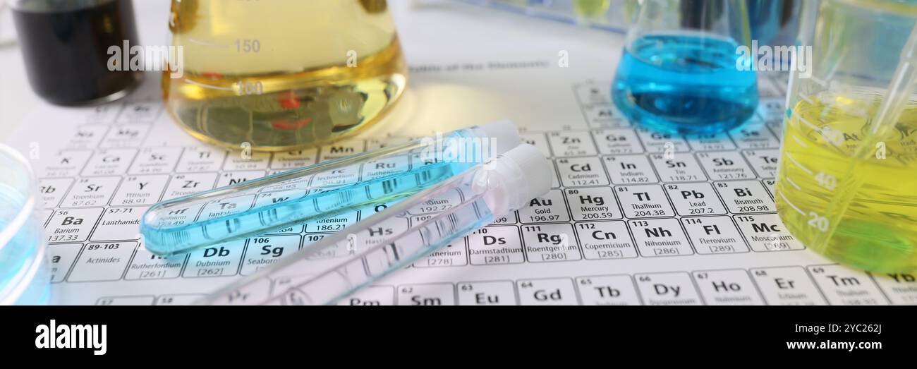 Glass flasks and test tubes with liquid on Mendeleev table Stock Photo ...